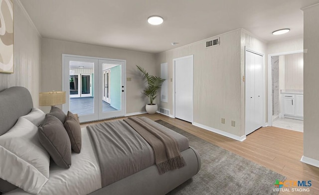 309 E Xavier Ave, Temple, TX 76501 - bedroom with wood finished floors, access to exterior, ensuite bathroom, and french doors