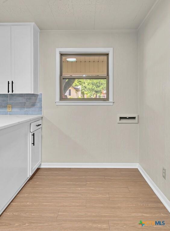 309 E Xavier Ave, Temple, TX 76501 - washroom featuring light wood finished floors and crown molding