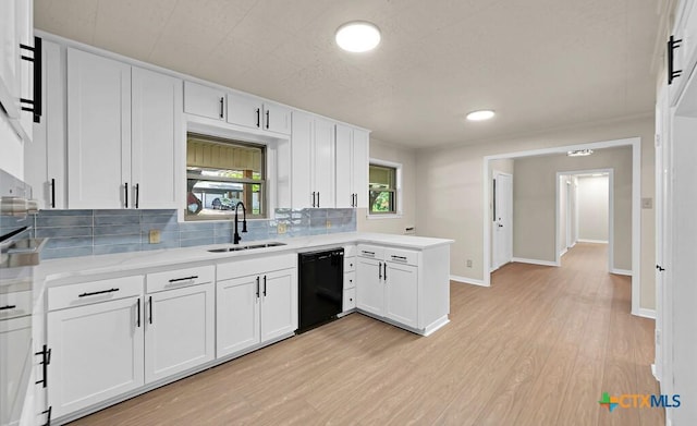 309 E Xavier Ave, Temple, TX 76501 - kitchen with dishwasher, backsplash, light wood-type flooring, and white cabinetry