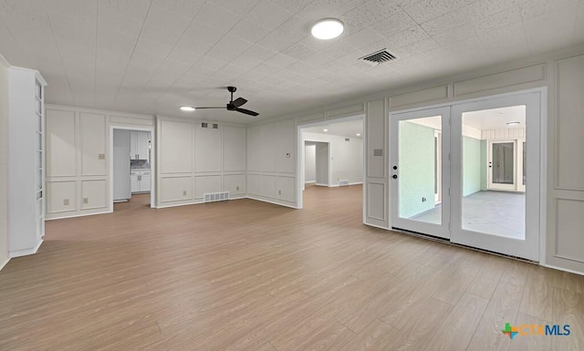 309 E Xavier Ave, Temple, TX 76501 - unfurnished living room featuring a decorative wall, a ceiling fan, and light wood-type flooring