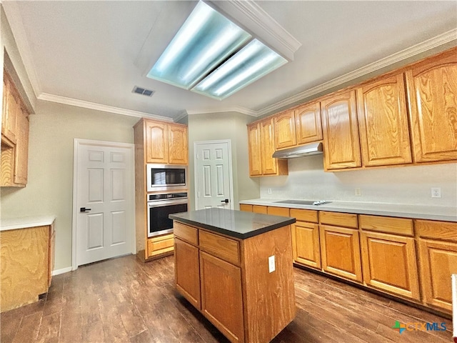 kitchen with stainless steel appliances, a kitchen island, dark hardwood / wood-style floors, and ornamental molding