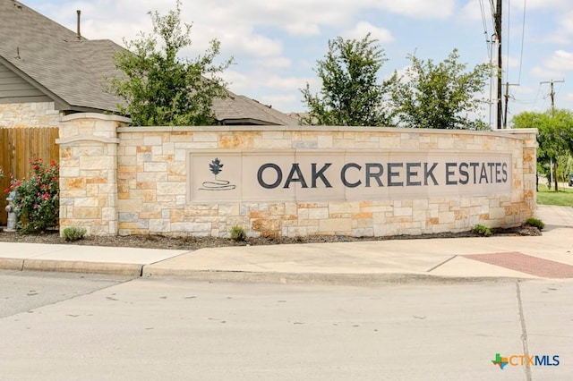 community sign featuring fence