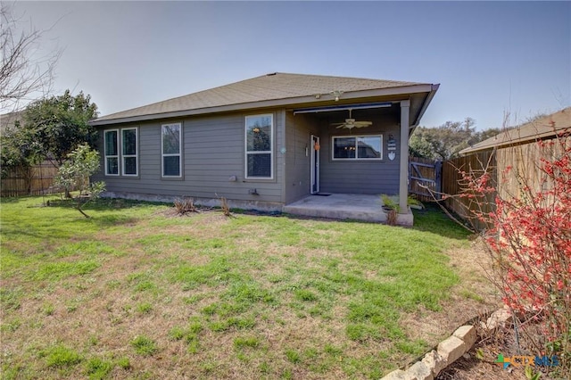 rear view of house featuring a fenced backyard, a patio area, a yard, and a ceiling fan