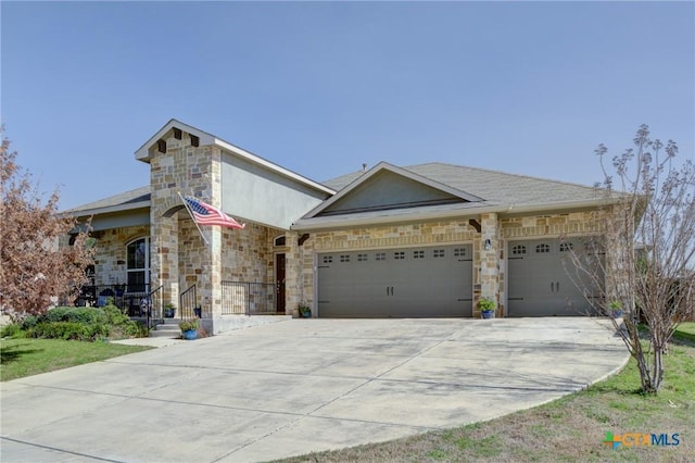 view of front facade featuring a garage, stone siding, and driveway