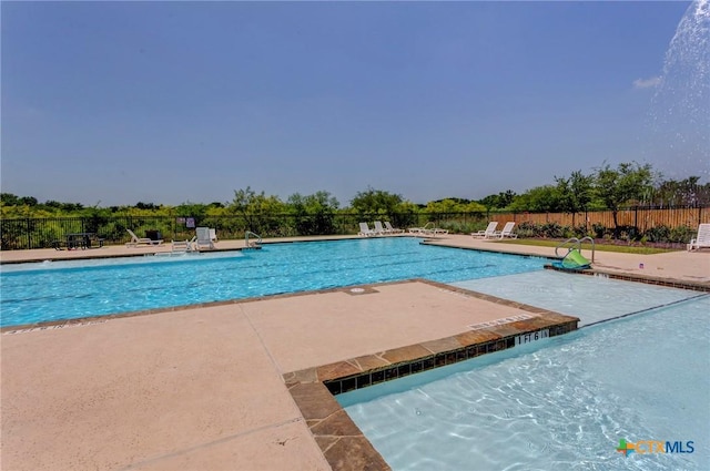 pool with fence and a patio area