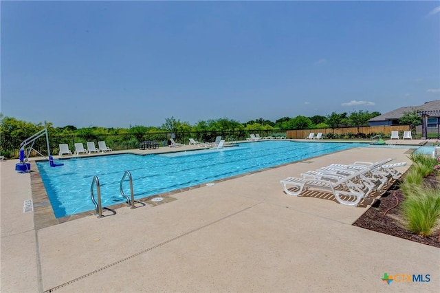 pool featuring a patio and fence