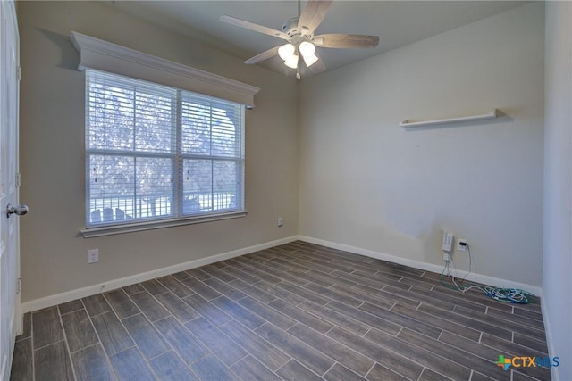 unfurnished room with ceiling fan, baseboards, and dark wood-style flooring