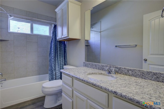 full bathroom featuring shower / bath combo with shower curtain, toilet, wood finished floors, and vanity