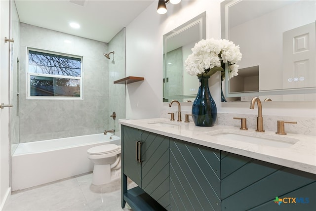 full bathroom featuring tiled shower / bath, vanity, and toilet