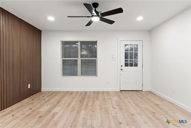 foyer with ceiling fan and light wood-type flooring