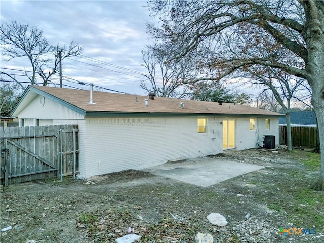 rear view of house featuring a patio and central AC unit