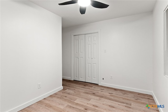 unfurnished bedroom with ceiling fan, light hardwood / wood-style floors, and a closet