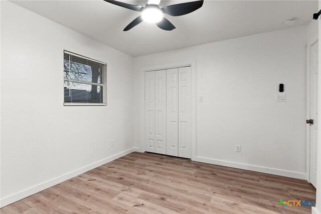 2802 Oakdale Dr, Temple, TX 76502 - unfurnished bedroom featuring light wood finished floors, baseboards, a closet, and ceiling fan