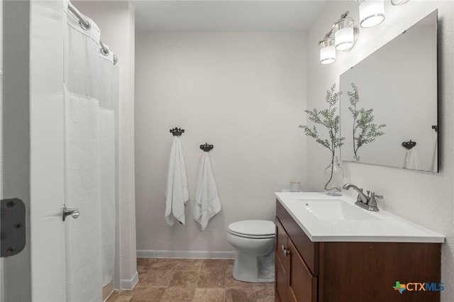 2002 E Young Ave, Temple, TX 76501 - bathroom featuring vanity, toilet, baseboards, and a shower with shower curtain