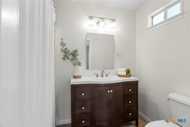 2002 E Young Ave, Temple, TX 76501 - bathroom with vanity, toilet, baseboards, and curtained shower