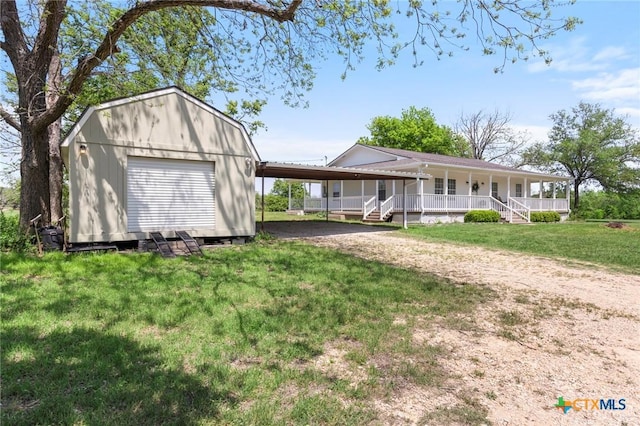 2002 E Young Ave, Temple, TX 76501 - view of front facade featuring covered porch, an outdoor structure, a front yard, and driveway