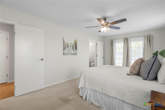 2002 E Young Ave, Temple, TX 76501 - bedroom with carpet flooring, baseboards, ensuite bath, and ceiling fan