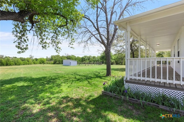2002 E Young Ave, Temple, TX 76501 - view of green lawn with a deck, a storage shed, and an outbuilding