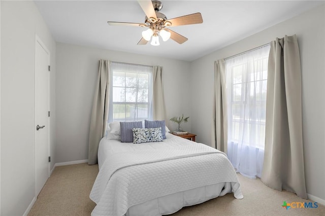 2002 E Young Ave, Temple, TX 76501 - bedroom with light carpet, baseboards, and ceiling fan