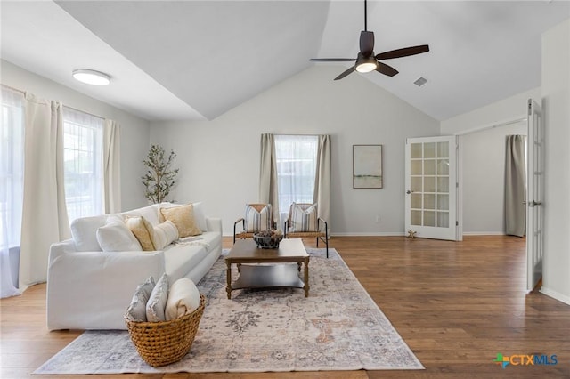 2002 E Young Ave, Temple, TX 76501 - living room featuring wood finished floors, a ceiling fan, lofted ceiling, and baseboards