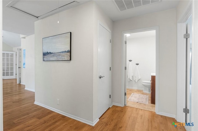2002 E Young Ave, Temple, TX 76501 - hall with attic access, light wood-style floors, and baseboards