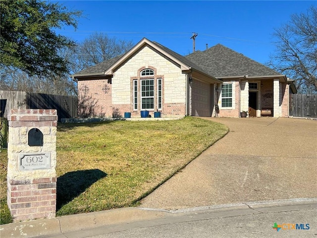 ranch-style home featuring a garage and a front lawn