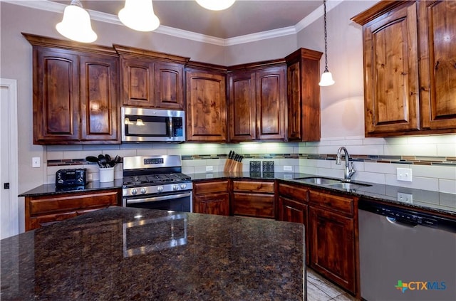 kitchen featuring decorative backsplash, sink, pendant lighting, and appliances with stainless steel finishes