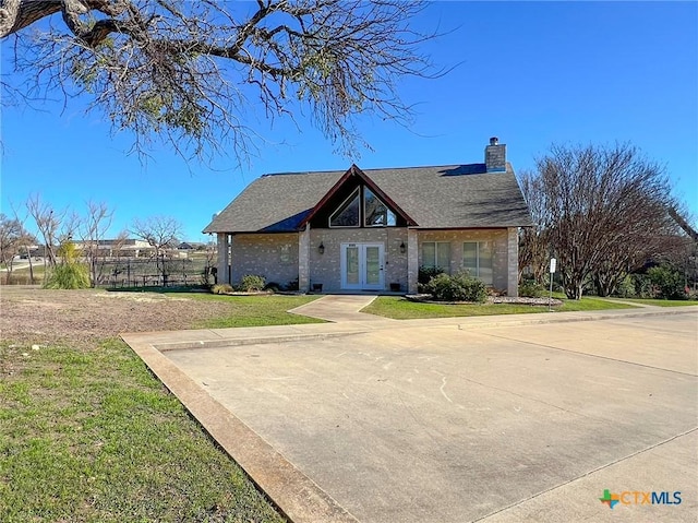 view of front of home featuring a front yard and french doors