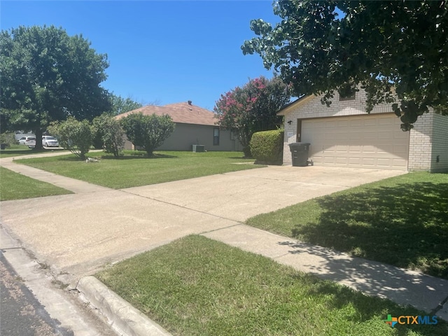 exterior space with a garage and a front lawn