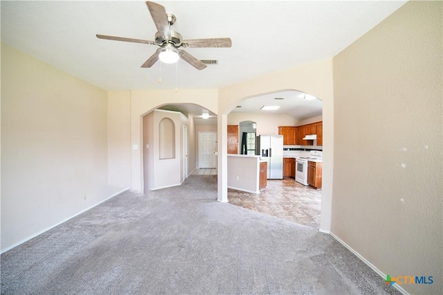 4607 Stanford Dr, Killeen, TX 76542 - unfurnished living room with arched walkways, ceiling fan, light carpet, and baseboards