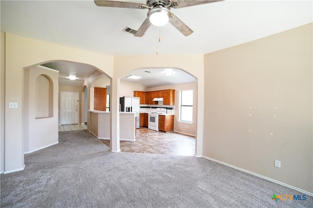 4607 Stanford Dr, Killeen, TX 76542 - unfurnished living room with light colored carpet, a ceiling fan, arched walkways, and baseboards