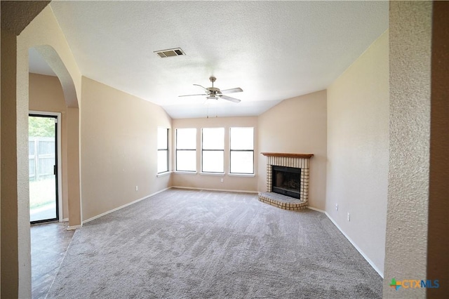 4607 Stanford Dr, Killeen, TX 76542 - unfurnished living room featuring a ceiling fan, plenty of natural light, a fireplace, carpet flooring, and vaulted ceiling