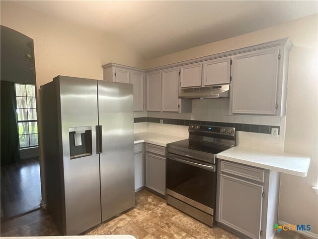 4607 Stanford Dr, Killeen, TX 76542 - kitchen with appliances with stainless steel finishes, under cabinet range hood, gray cabinets, light countertops, and decorative backsplash