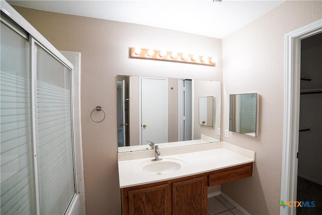 4607 Stanford Dr, Killeen, TX 76542 - full bathroom featuring a shower with door, tile patterned flooring, and vanity