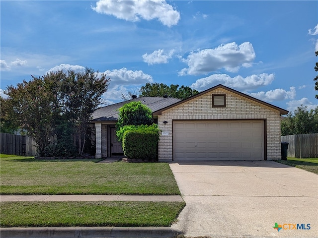 single story home with a garage and a front lawn