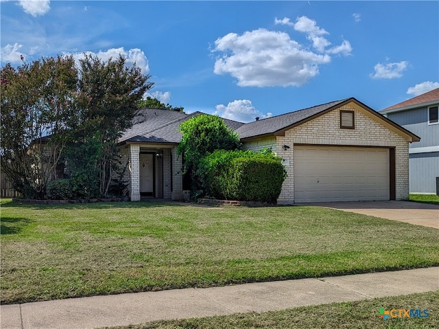 view of front of property with a garage and a front lawn