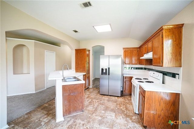 4607 Stanford Dr, Killeen, TX 76542 - kitchen with stainless steel refrigerator with ice dispenser, electric range, under cabinet range hood, a sink, and arched walkways