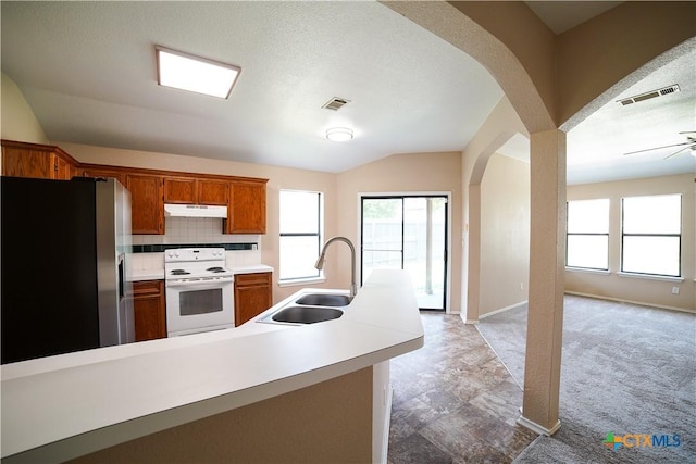 4607 Stanford Dr, Killeen, TX 76542 - kitchen featuring electric stove, a sink, stainless steel refrigerator with ice dispenser, under cabinet range hood, and arched walkways