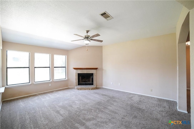 4607 Stanford Dr, Killeen, TX 76542 - unfurnished living room featuring carpet, a ceiling fan, a brick fireplace, and baseboards