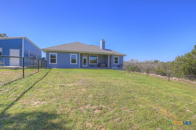 315 Hilltop Rdg, New Braunfels, TX 78132 - rear view of house featuring fence, a lawn, and a chimney