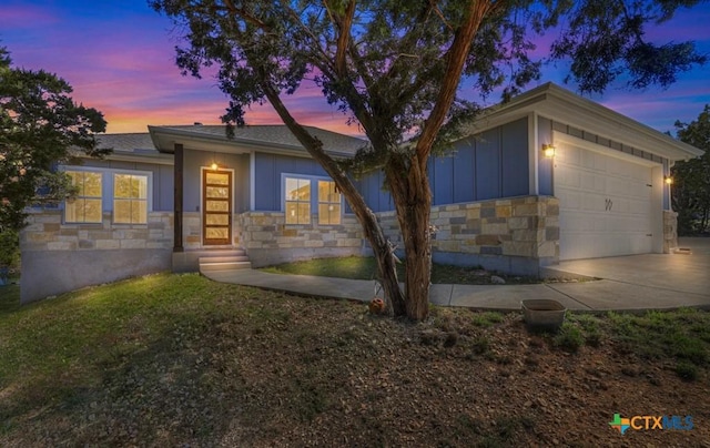 315 Hilltop Rdg, New Braunfels, TX 78132 - view of front of house with board and batten siding, driveway, a garage, and stone siding