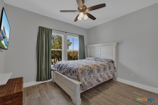 315 Hilltop Rdg, New Braunfels, TX 78132 - bedroom with baseboards, a ceiling fan, and wood tiled floor