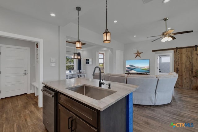 315 Hilltop Rdg, New Braunfels, TX 78132 - kitchen featuring a barn door, dishwasher, dark wood-style flooring, and a sink