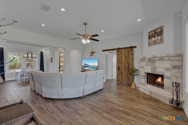 315 Hilltop Rdg, New Braunfels, TX 78132 - living area featuring visible vents, recessed lighting, a barn door, and wood finished floors
