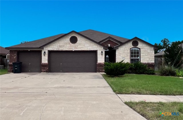 view of front of house with a garage and a front lawn