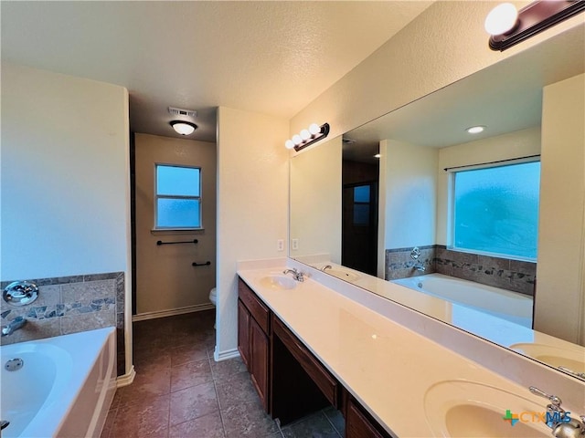 4002 Salt Fork Dr, Killeen, TX 76549 - full bathroom with a garden tub, double vanity, toilet, tile patterned floors, and baseboards