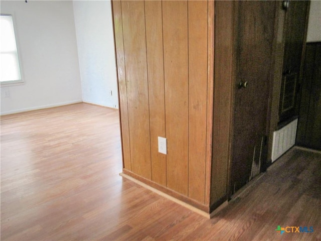 hallway with baseboards and wood finished floors