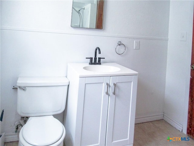bathroom featuring vanity, tile patterned flooring, and toilet