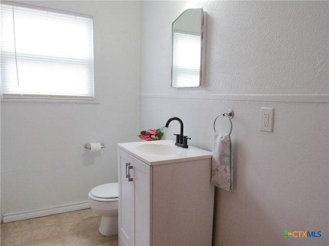 bathroom featuring toilet, tile patterned flooring, and vanity