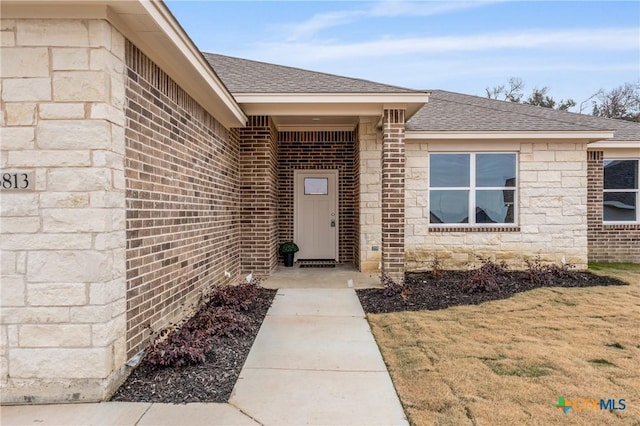 entrance to property featuring a lawn